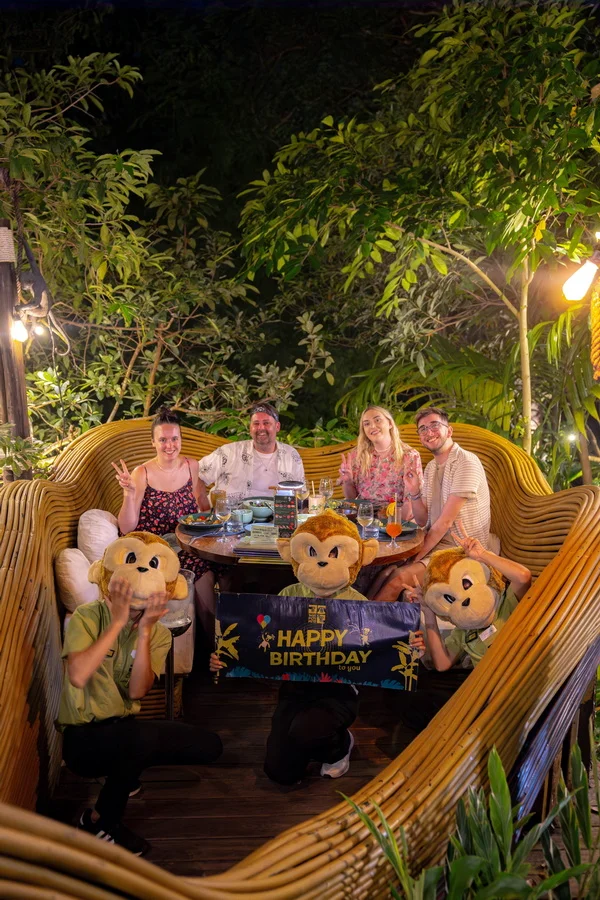 Birthday table with cake and decorations in a curved seating area
